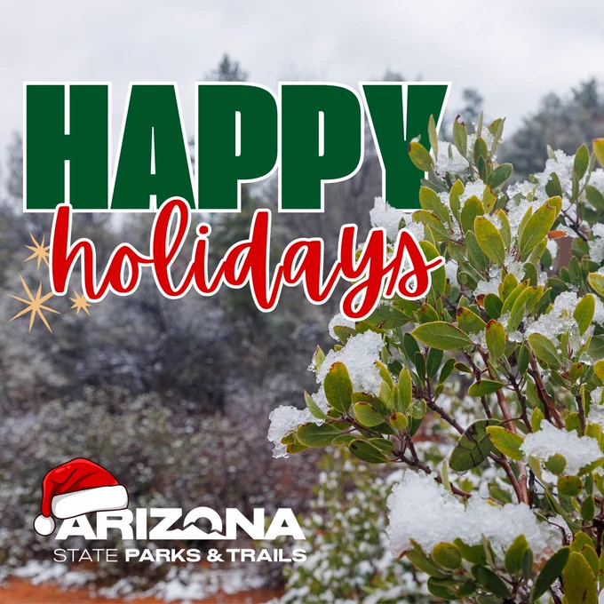 Happy Holidays" message from Arizona State Parks & Trails, featuring a manzanita plant with green leaves lightly covered in snow.