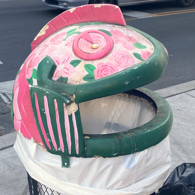 A shot of the pink rose-covered fishhead trashcan near the Rose Garden in Fishtown.