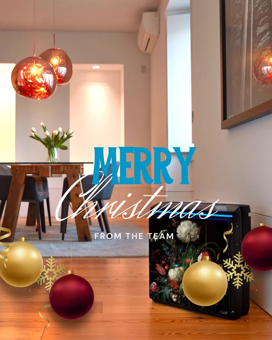 Modern living room decorated for Christmas with festive ornaments, a stylish air purifier, and a Merry Christmas greeting from the team.