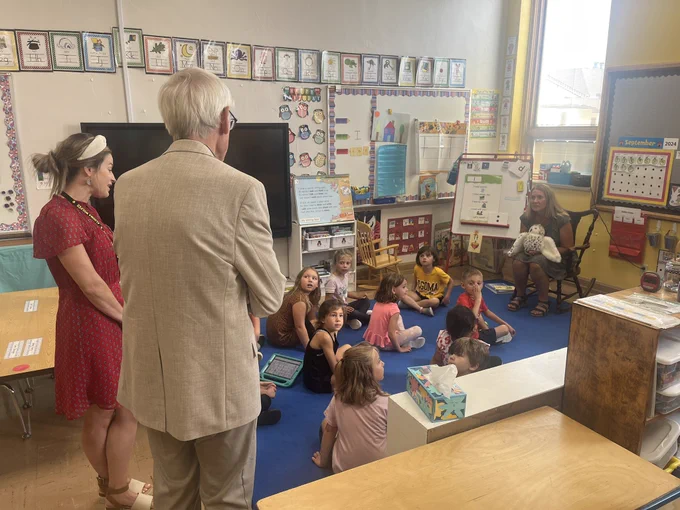 Gov. Evers talks to teachers and kids in classroom.
