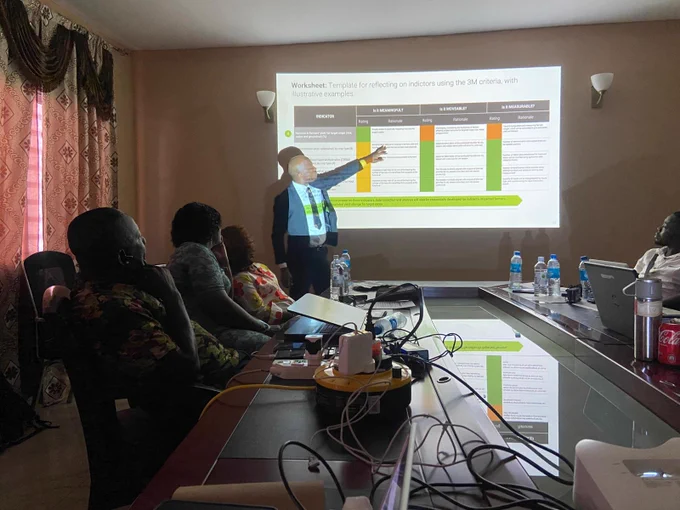 Facilitator (Sani) explaining the 3M Criteria framework, followed by an interactive session and a prioritization exercise where participants applied the framework (Meaningful, Moveable, Measurable) to rank project indicators.
