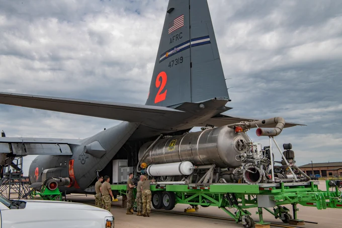 Aircraft is being loaded with a tank.