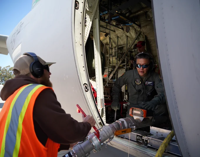 Two personnel work together in a MAFFS.