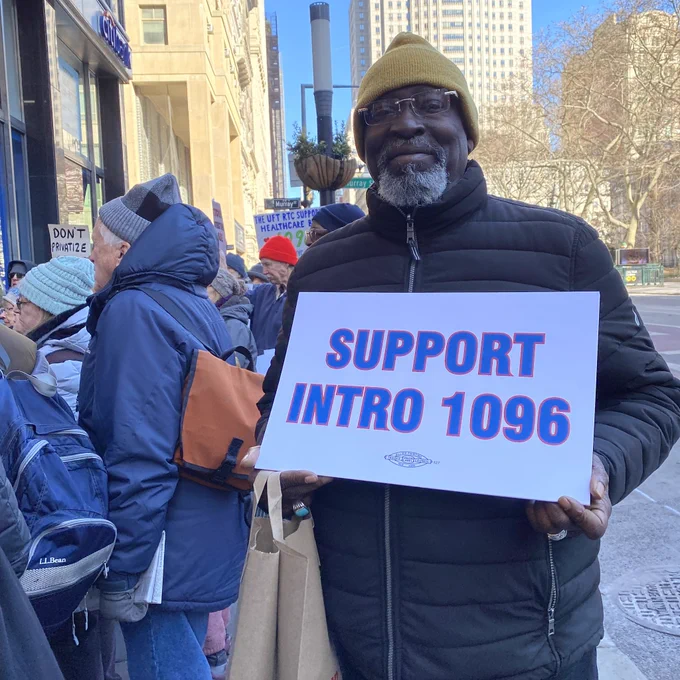 Retiree holding a sign saying support intro 1096