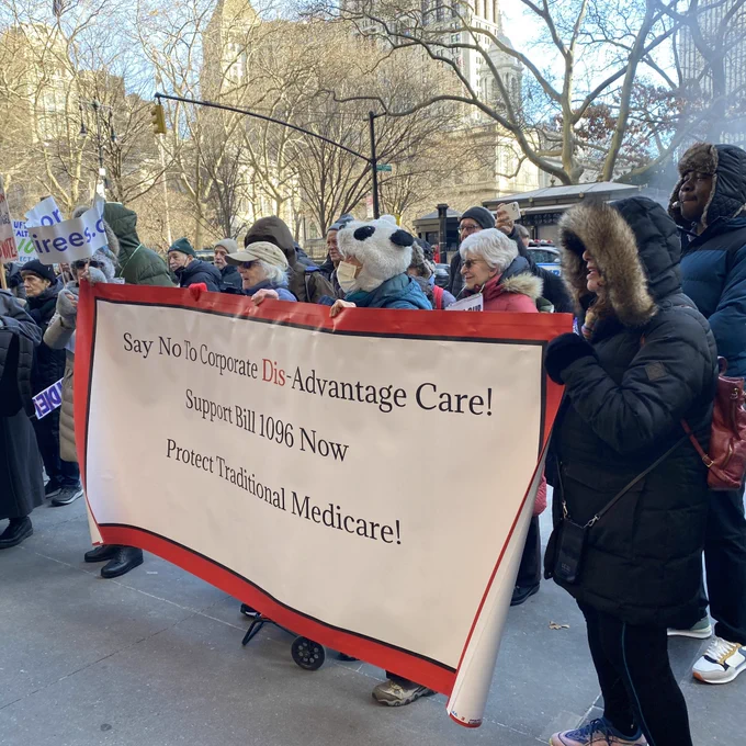 Retirees holding a banner opposing Medicare Advantage