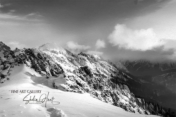 Black and white winter scene of snowy ridges, misty fog, and clouds in the Blue Ridge Mountains of Western North Carolina near Grandfather Mountain.  From the Fine Art Gallery of Shelia Hunt at Shelia-Hunt.pixels.com