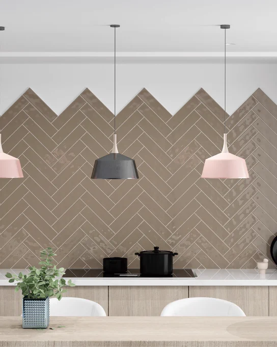 A close up view of a latte coloured glossy subway tile. Kitchen, accent wall, dining table, white grout.