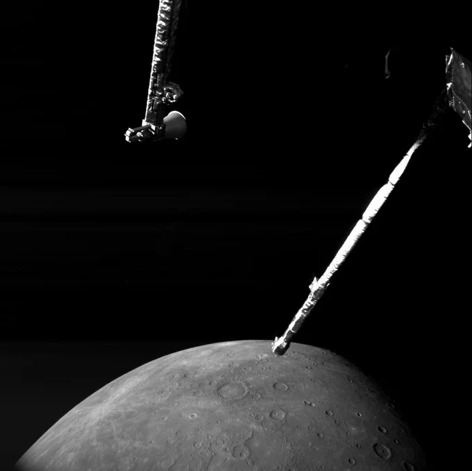 Image taken by BepiColombo during its sixth Mercury flyby. Planet Mercury is visible in the background with its grey, cratered, pock-marked surface. In the foreground are some spacecraft parts.