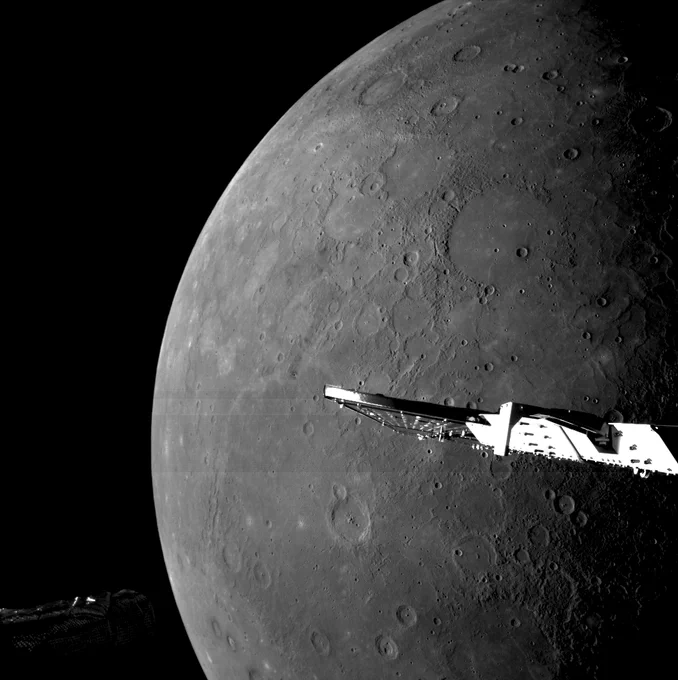 Image taken by BepiColombo during its sixth Mercury flyby. Planet Mercury is visible in the background with its grey, cratered, pock-marked surface. In the foreground are some spacecraft parts.