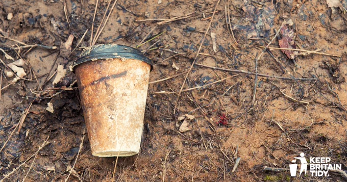 photo of a discarded coffee cup on the floor