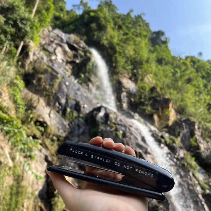 Here's the 4th floor stapler in the sunshine, under a waterfall. We're not sure where it is, but we would much rather be there than here.