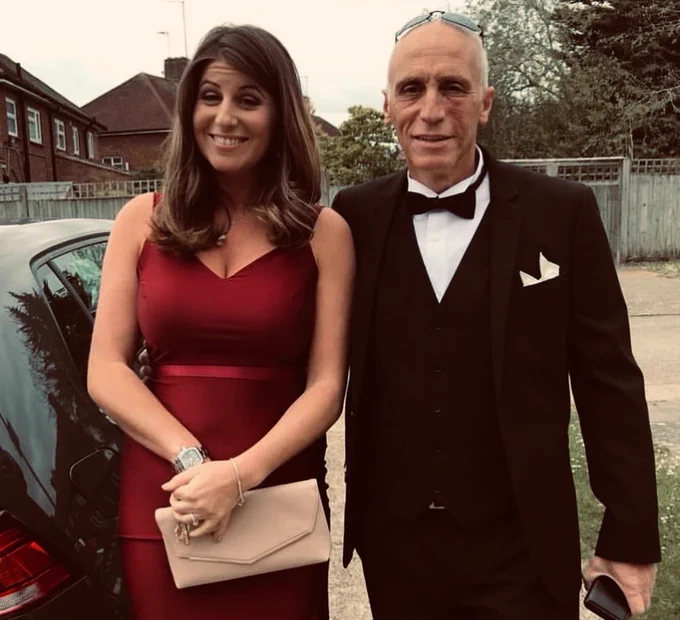 Michael wearing a bow tie and black suit, stood next to his daughter Ellianna, who is wearing a red dress.