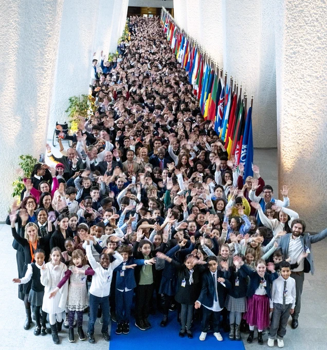 ILO Director-General, Gilbert F. Houngbo, stands with young participants at the FerMun model UN at the ILO in Geneva. Photo: Alioune Ndiaye. 