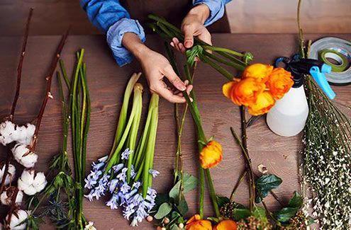 A person working on a flower arrangement