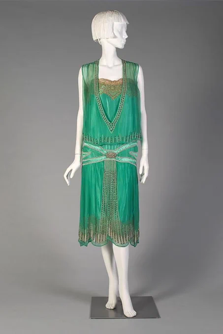 Sleeveless green evening dress embellished with shaded green motifs