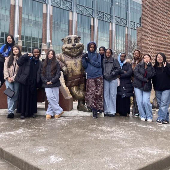 Group of students standing next to the Goldy gopher statue at the University of Minnesota.