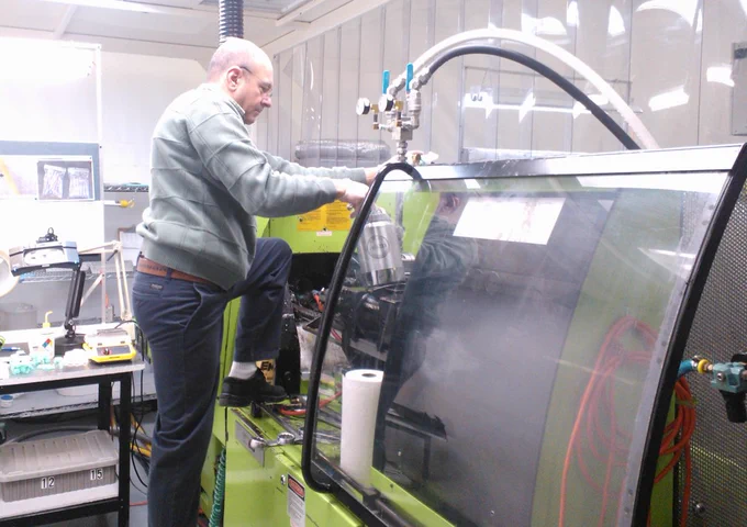 Prepping the injection molding press for a sample run.