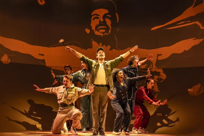 The cast have arms outstretched and excited!