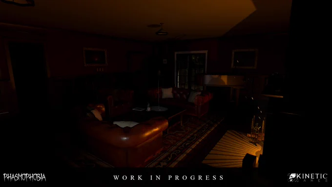 Screenshot showing a work in progress update for the Bleasdale Farmhouse map from the game Phasmophobia. It shows a dimly-lit room featuring red leather sofas in front of a lit fire.