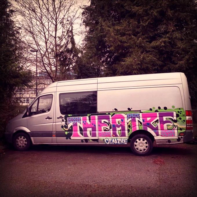 A photo of the Theatre Centre van, featuring graffiti-style artwork saying 'Theatre Centre', designed and painted by Cherry Bee.