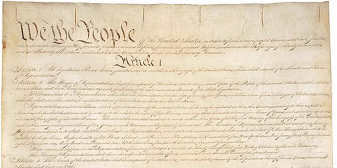 The colored photo on the right is a section of the Constitution of the United States.
