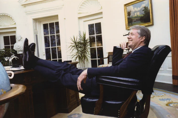A throwback photo of President Carter behind the Resolute Desk in the Oval Office.