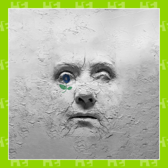 The poster has a textured, gray background resembling cracked dry clay. At the center, there is a sculptural face emerging from the surface, appearing as though molded from the same cracked material. The face looks weathered and expressionless, with deep shadows emphasizing its details.  On the left eye socket of the face, there is a small, delicate blue flower with a green stem and two leaves, standing out against the monochromatic background. This picture is in a green Hackney Empire Border