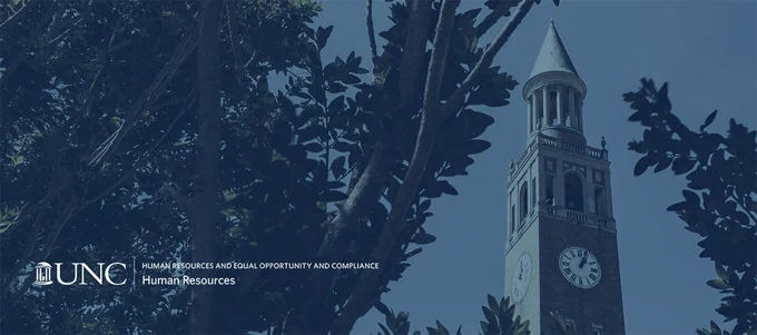 UNC Human Resources and Equal Opportunity and Compliance - trees in the foreground framing the UNC Belltower in the background
