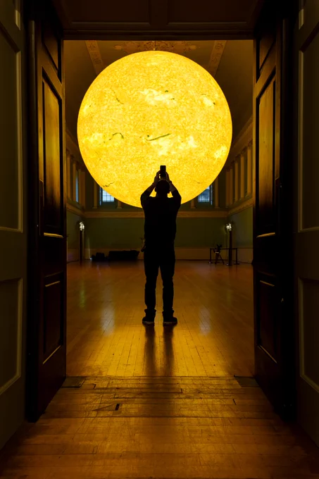 A person taking a picture of Helios in the Ball Room at Bath Assembly Rooms.
