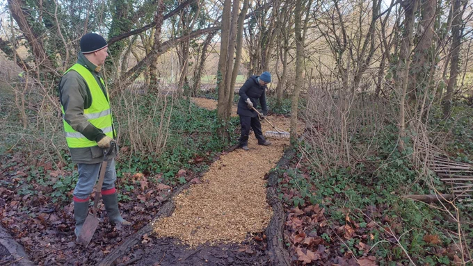 Two volunteers working on the pathway repairs on Tooting Commons