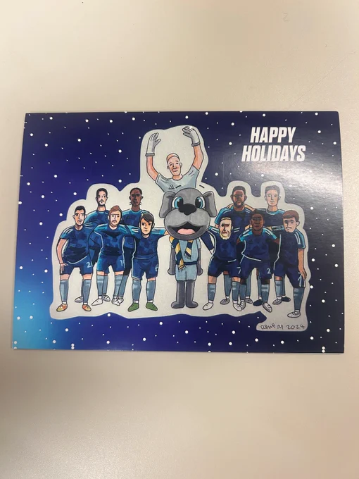Happy Holidays card featuring the Sporting Kansas City mascot with soccer players, set against a starry night background.