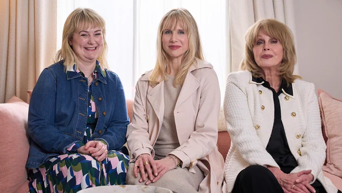 Anne (Philippa Dunne), Amanda (Lucy Punch) and Felicity (Joanna Lumley) sit next to each other on a sofa and smile to camera. 