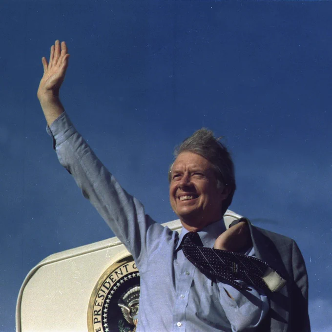 President Jimmy Carter waves from the steps of Air Force One in 1977.