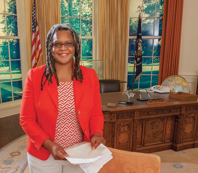 Meredith Evans stands in a replica of the Oval Office at the Jimmy Carter Presidential Library. She holds the letter she mailed to Jimmy Carter when she was 4.