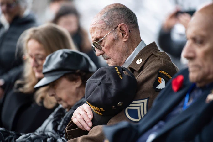 A veteran holds his hat over his heart during a Battle of the Bulge memorial service.