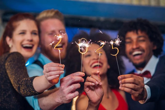 Group of people holding a 2025 light firework.