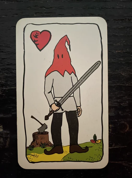 a playing card with an executioner and sword