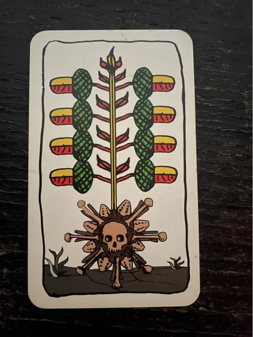 playing card with acorns and a skull motif
