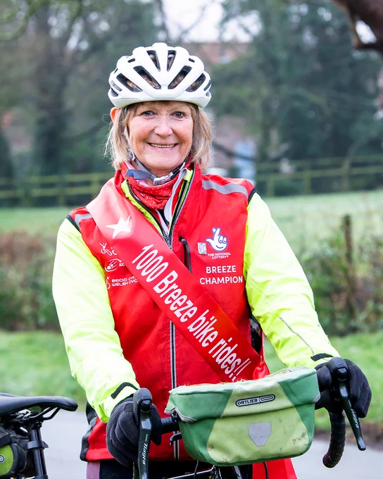 Val French in her Breeze kit and 1000 rides sash celebrates her milestone 