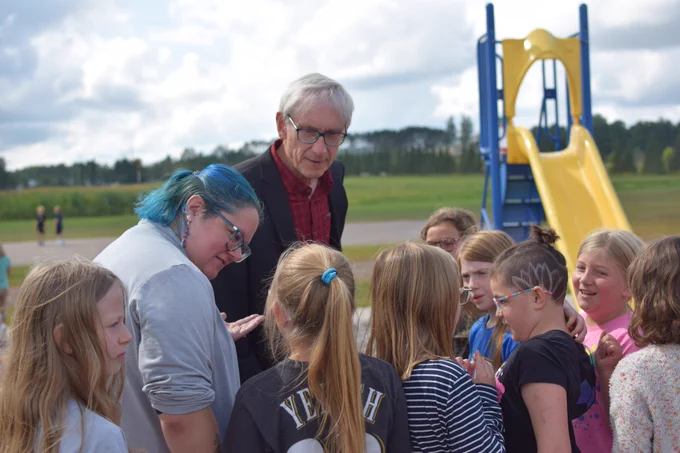 Gov. Evers talks to students on the playground