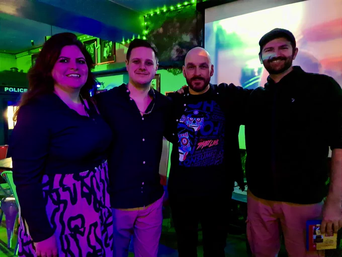 Becky Casey, Brandon McCaffrey, Pete Tomkies, and Sam Jones pose for a photo.