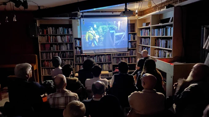 A crowd watch Secrets of a Wallaby Boy in Hyde Park Book Club, Leeds.