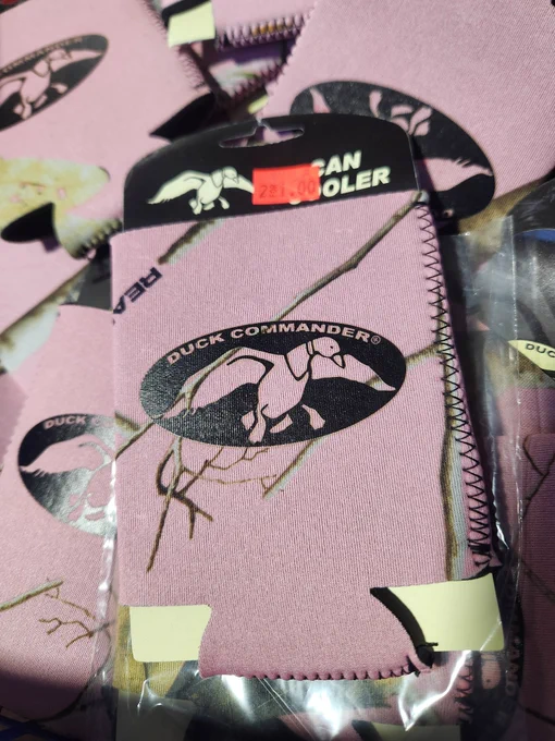 "DUCK COMMANDER" coozie (pink with green and teal camo with an open wingspan duck that says DUCK COMMANDER on it. 