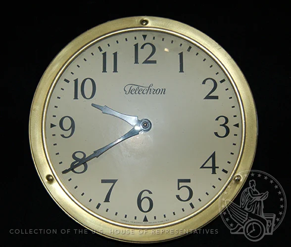 Analog clock from brand Telechron with gold rim