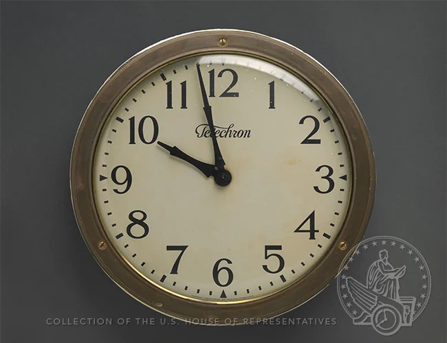 Analog clock from brand Telechron with brass rim