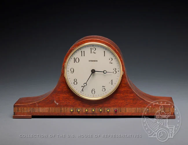 Red-stained wood mantle clock.