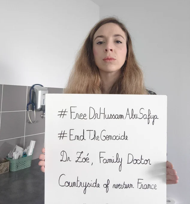 Photo de moi (Dr Zoé) dans p slle de consultation avec une pancarte.
#FreeDrHussamAbuSafiya
#EndTheGenocide
Dr Zoé, family doctor
Countryside of western France 