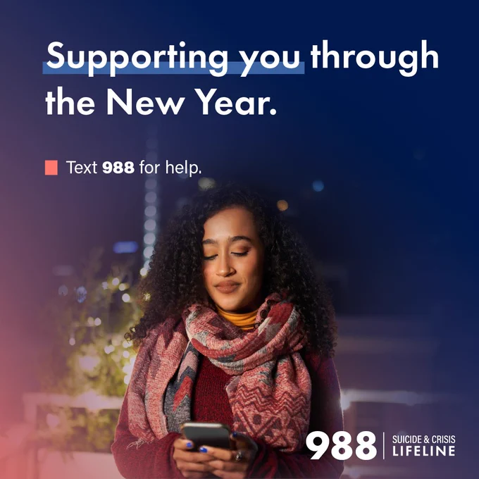 Promotional image for the Suicide and Crisis Lifeline featuring an individual using a smartphone, with text 'Supporting you through the New Year. Text 988 for help.' set against a nighttime backdrop.