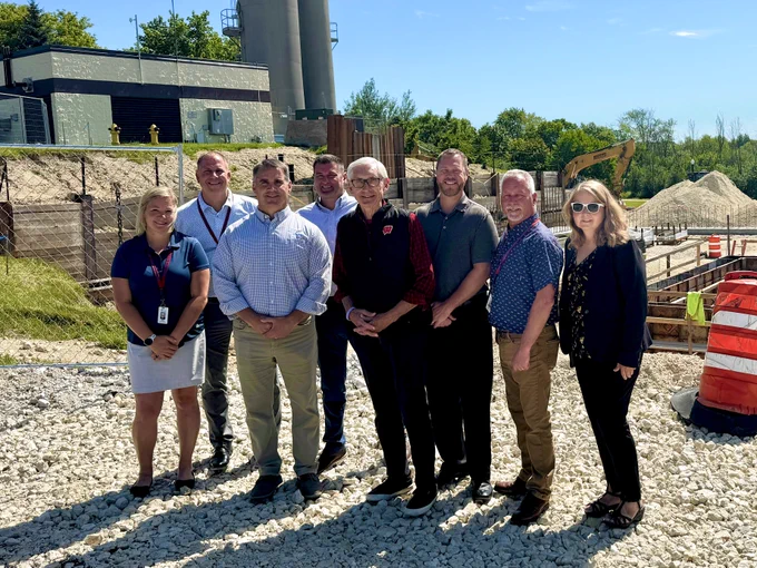 Gov, Evers poses for a group photo with local leaders at well in West Bend.
