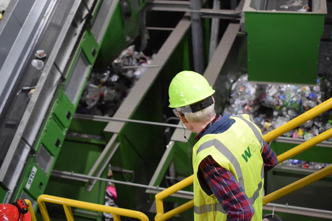 Gov. Evers tours a recycling facility. 
